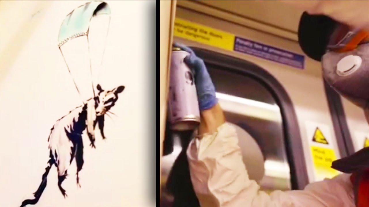 Ein Screenshot aus dem neuen Banksy-Video, in dem der Künstler in der Londoner U-Bahn mit Stencils für das Tragen von Mund-Nasen-Schutz wirbt