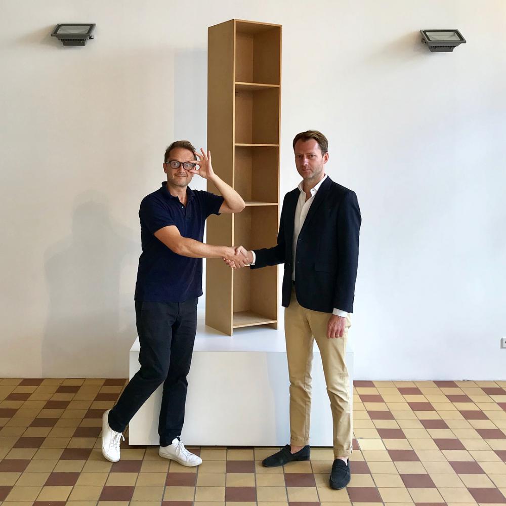  Rafael Horzon und Mateo Kries (Direktor des Vitra Design Museums) schütteln sich die Hand vor einem HORZON-Regal